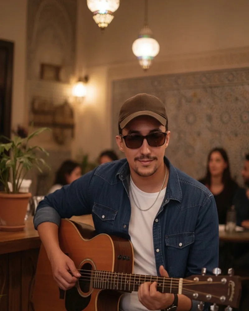 Jocker Wink playing an acoustic guitar in a warm room